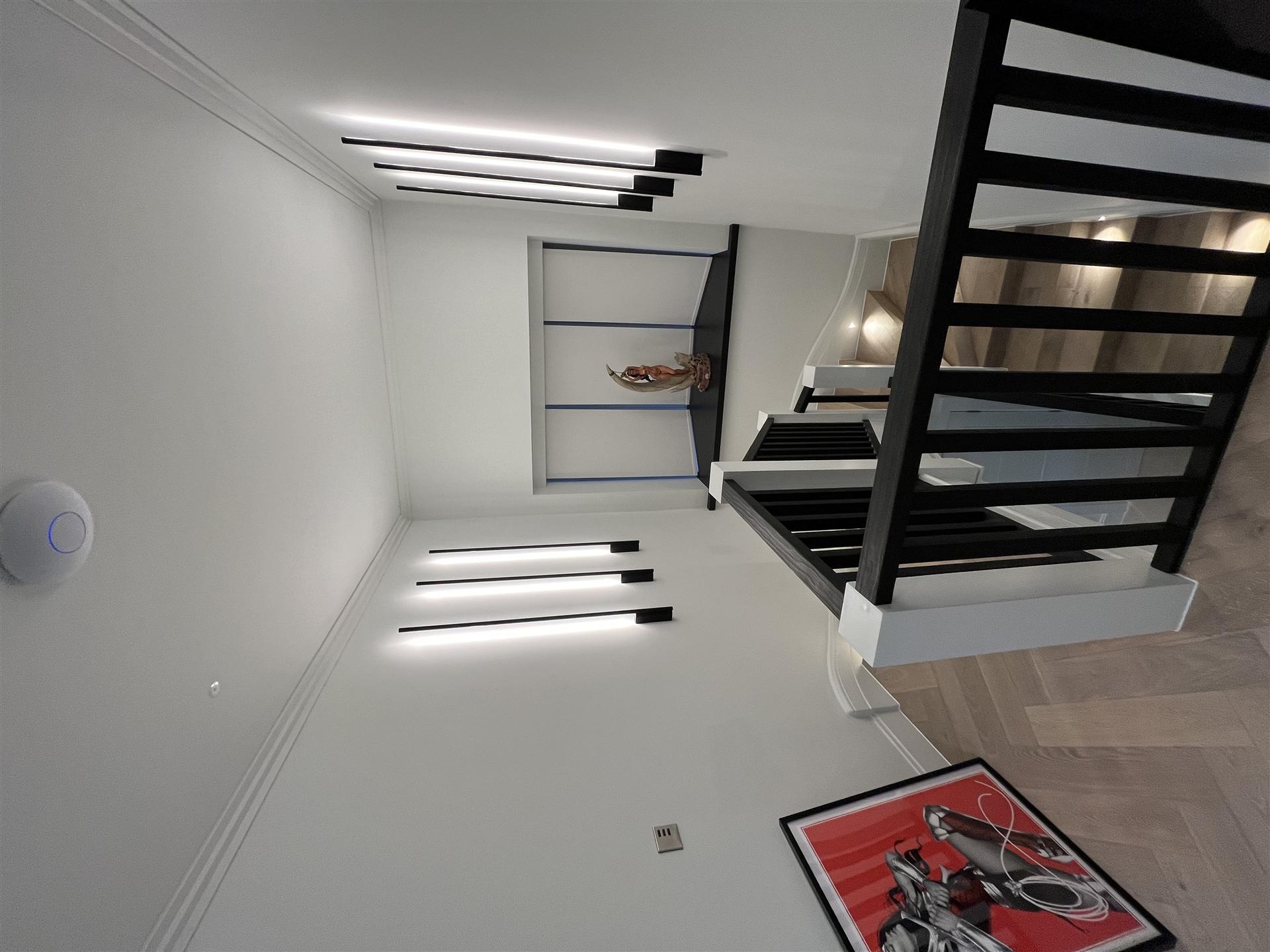 Staircase with floating display shelving and LED lighting, Essex